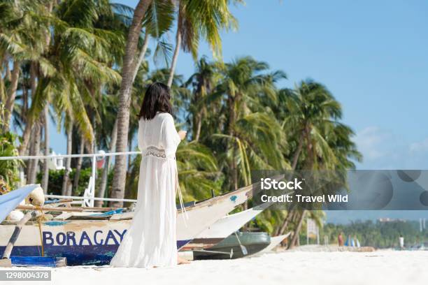 Stunning View Of A Girl Dressed In White Walking On A Beach During A Beautiful Sunny Day White Beach Boracay Island Philippines Stock Photo - Download Image Now