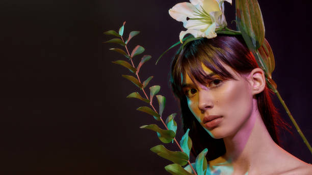 istock Lady is holding a branch with leaves 1298005441
