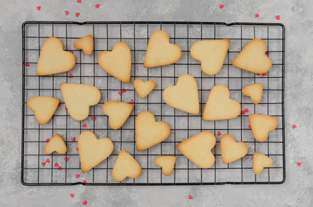 istock Ready heart-shaped shortbread cookies for Valentine's Day on the gray background. Recipe step by step. Valentine's Day food background. Top view. 1298005538