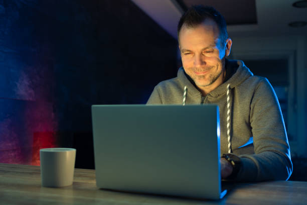 istock Man chatting and smiling at night 1298005790