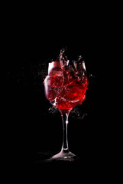 Broken wine glass on black background.Red wine Broken wine glass on black background.Red wine crystal chalice stock pictures, royalty-free photos & images