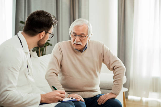 istock Young doctor and senior man having a serious conversation 1298012161