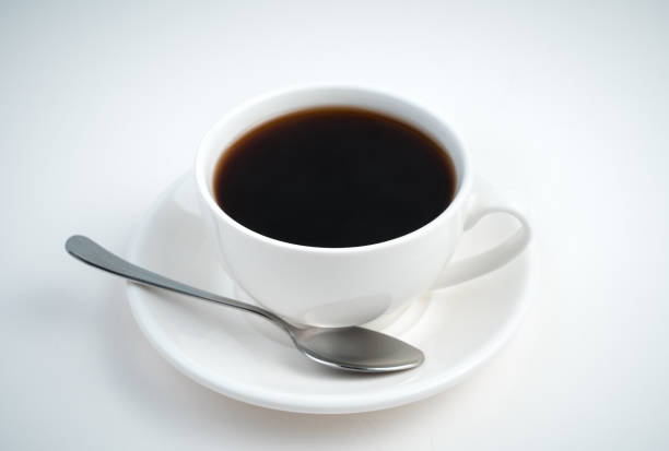 istock A Cup of coffee and a saucer with a spoon on a light background 1298013679