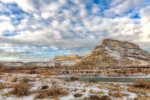 beautiful clouds roll over the desert buttes at Colorado State Park, James M. Robb Island acres state park on a winter day with the Colorado River running through it