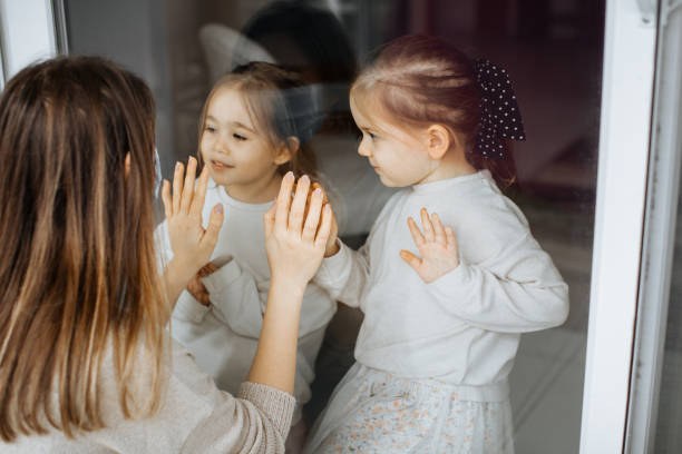 istock A Daughters Visiting Her Quarantined Mother Preventing Contracting Corona Virus Through The Window 1298013832