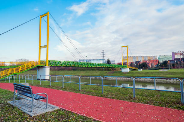 istock bench in a park area near a river and bridge 1298014714