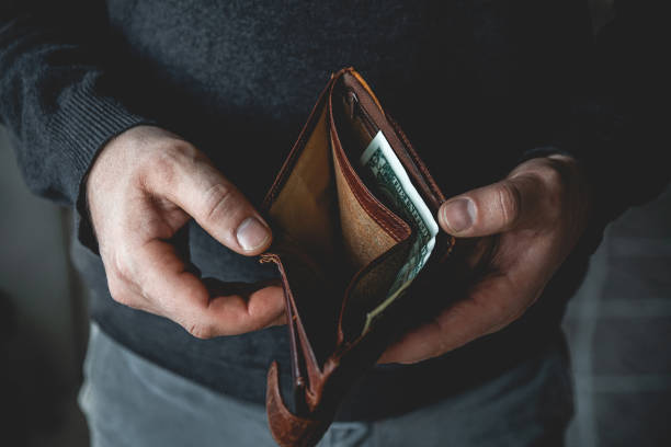 istock Empty wallet in the hands of a young man 1298015230