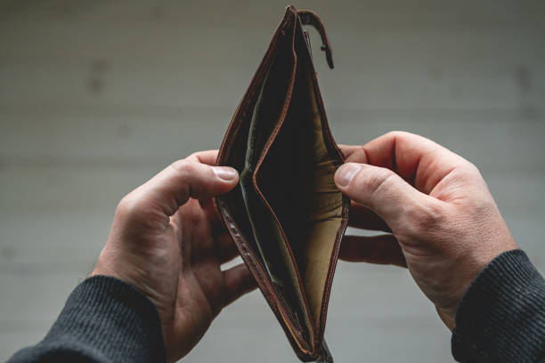 istock Empty wallet in the hands of a young man 1298015287