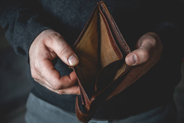 istock Empty wallet in the hands of a young man 1298015306
