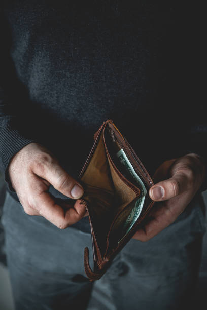 istock Empty wallet in the hands of a young man 1298015820