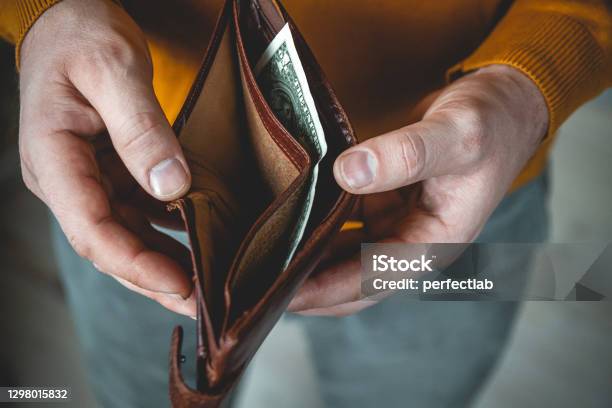 Empty Wallet In The Hands Of A Young Man Stock Photo - Download Image Now - Empty Wallet, Open, Wallet