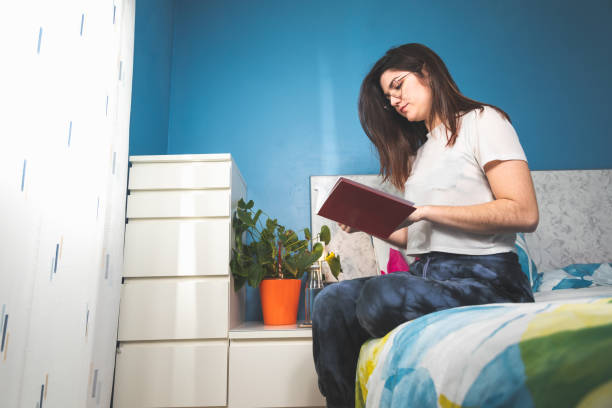 istock Woman reading at the bed 1298016210