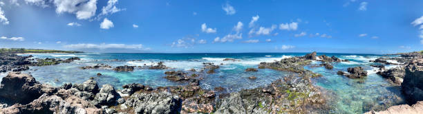 istock lava rocks and solashing blue waters at the coastline / ho’okipa beach park / panoramic view 1298017465