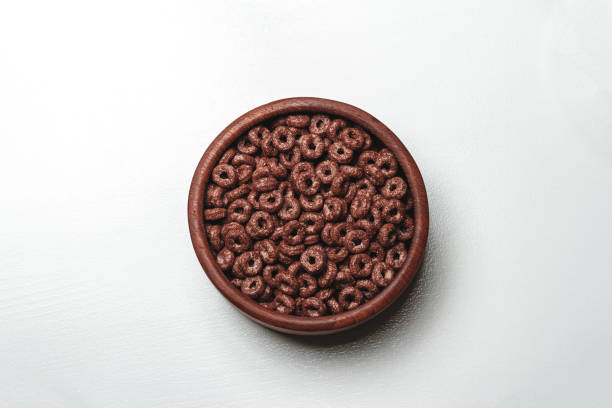 istock Wooden bowl with chocolate quick breakfast cereal on white backg 1298017702