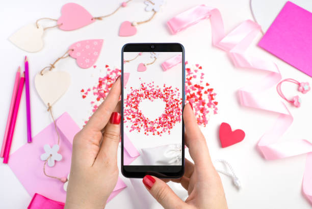 istock A woman's hands hold the phone over a romantic background 1298018114