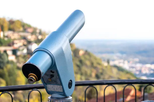 Photo of Spyglass looking out to the mountains in Como, Italy. Coin operated monocular viewer.