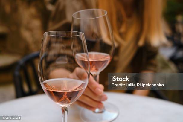 A Glass Of Rose Wine In The Hands Of A Girl Relaxing On Restaurant Terrace Summer Holiday Celebrate And Enjoy Moment Alcoholic Drink Tasting Romantic Evening Aperitif Wine Glass Closeup Stock Photo - Download Image Now