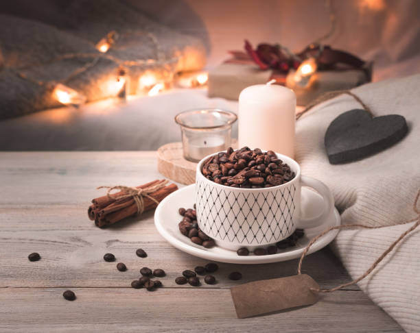 Festive background with coffee, candles and lights in the background