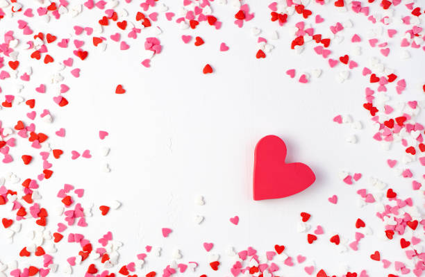 istock Red heart surrounded by small hearts on a light background 1298020766