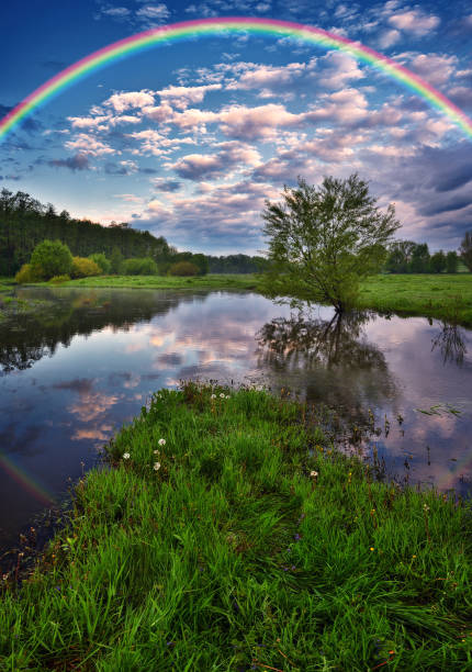 istock Landscape with a Rainbow on the River in Spring. colorful morning 1298021492