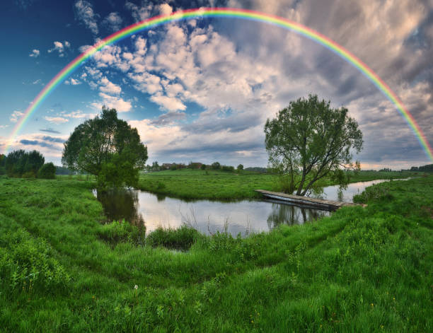 istock Landscape with a Rainbow on the River in Spring. colorful morning 1298021551