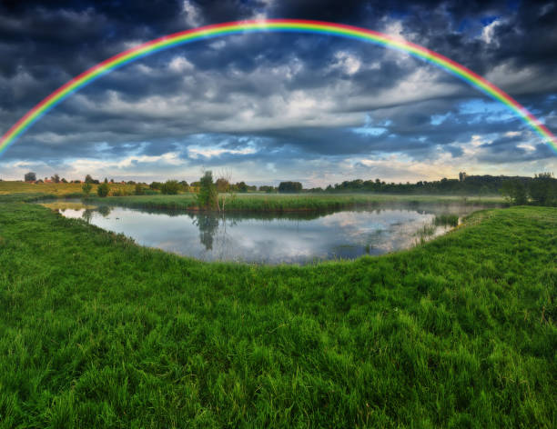 istock Landscape with a Rainbow on the River in Spring. colorful morning 1298021559