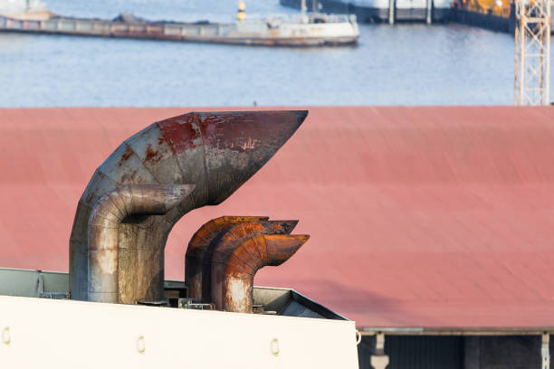 The exhaust pipe of the ship. Pipes of a sea liner close-up. Environmental pollution. City port