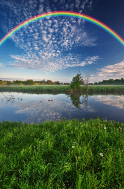 istock Landscape with a Rainbow on the River in Spring. colorful morning 1298021593