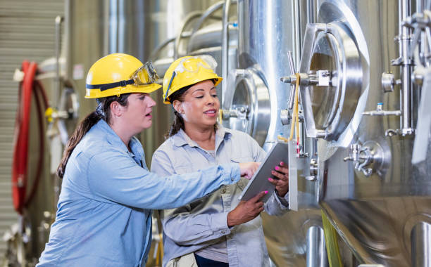 istock Two women working in factory, with digital tablet 1298022745