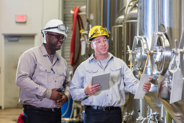 istock Two men working in factory, inspecting storage tank 1298022755