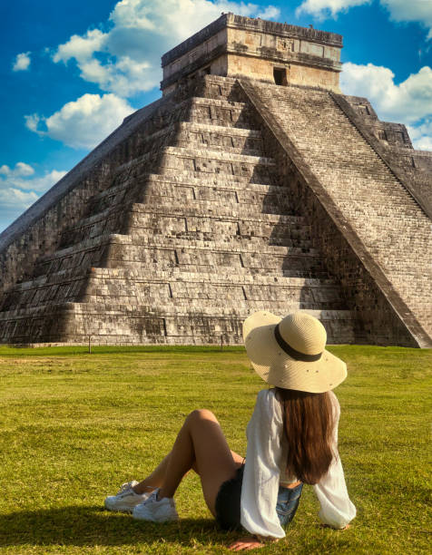 Chichen Itza Pyramid Tourist woman sitting in front of the Chichen Itza pyramid in Yucatan, Mexico. chichen itza photos stock pictures, royalty-free photos & images