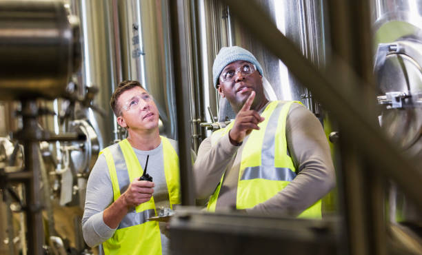 istock Two men working in factory, looking up 1298022808
