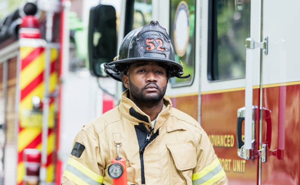 istock Firefighter in protective clothing outside fire truck 1298023357
