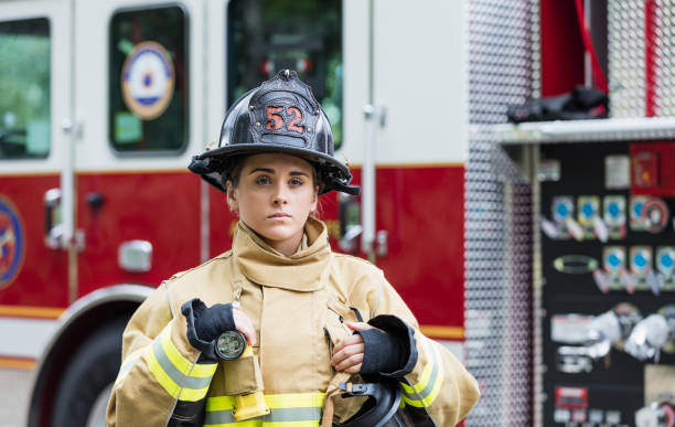 istock Female firefighter in fire protection suit 1298023358