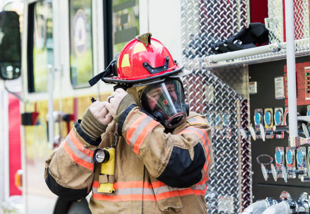 istock Firefighter in fire protection suit and respirator mask 1298023381
