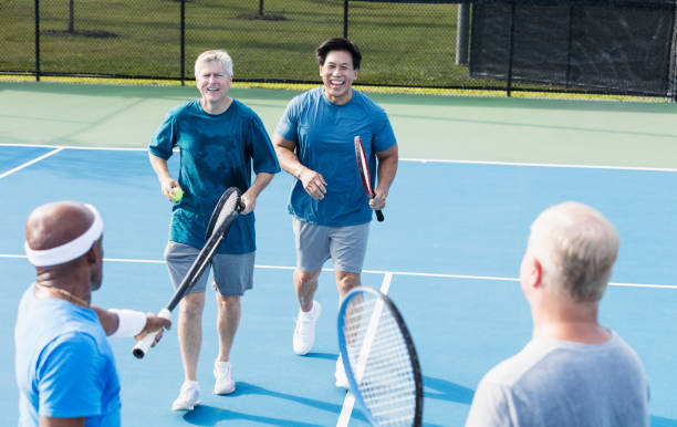 istock Men playing tennis, meeting at the net 1298023452