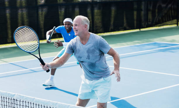 istock Men playing tennis, doubles team 1298023467