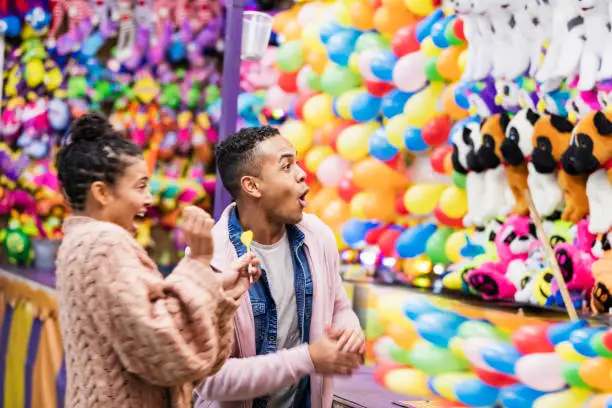 Photo of Young African-American couple playing carnival game