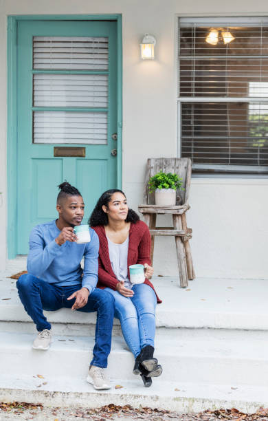 istock African-American couple hanging out, drinking coffee 1298023728