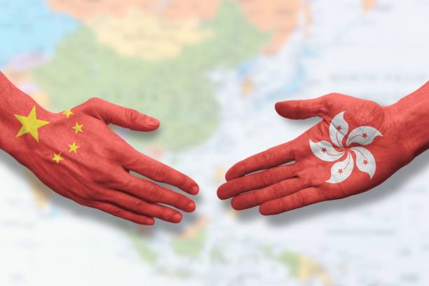 istock China and Hong Kong - Flag handshake symbolizing partnership and cooperation 1298025228