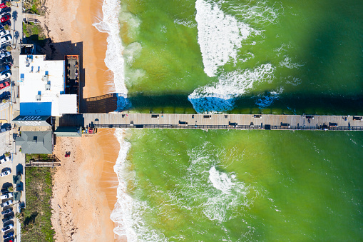 Flagler Beach, Florida USA - December 21, 2020: Aerial photo of Flagler Beach, Florida with pier, sand and waves.