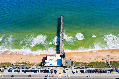 Flagler Beach, Florida USA - December 21, 2020: Aerial photo of Flagler Beach, Florida with pier, sand and waves.