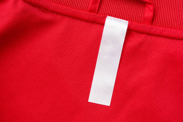 istock White blank clothes label on red jersey texture background 1298031056