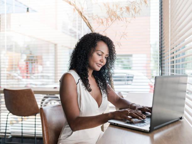 istock Young entrepreneur in her coffe shop working on laptop computer 1298031561