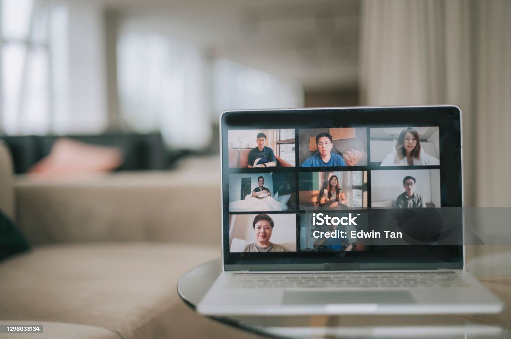 laptop screen showing 8 asian chinese face video conference in aiport departure business lounge sofa laptop screen showing 8 asian chinese face video conference in business lounge sofa Video Conference Stock Photo