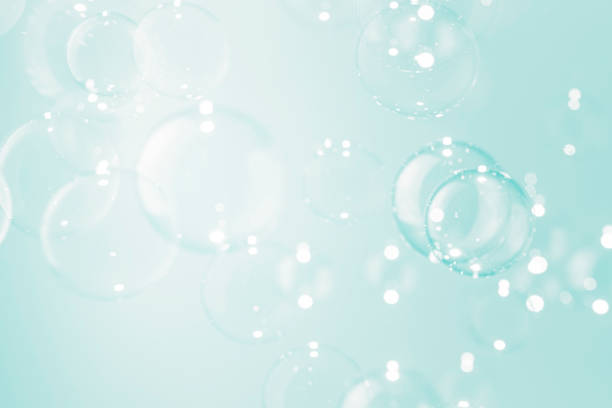 istock Beautiful blur transparent soap bubbles float on soft green background. 1298048009