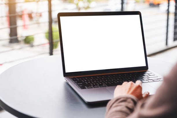 istock a woman using and touching on laptop computer touchpad with blank white desktop screen on the table 1298048739