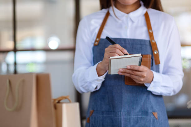 istock a female entrepreneur checking orders from customer 1298048755