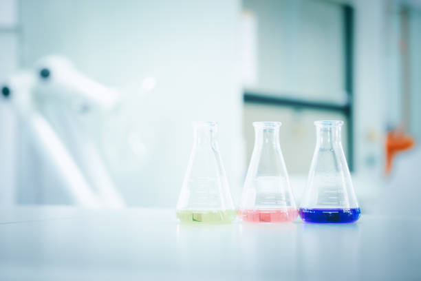 istock Laboratory flask with colorful liquids stirred inside in laboratory 1298056161