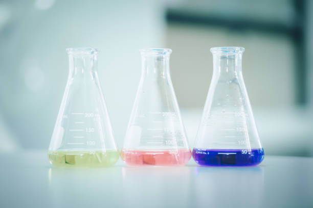 istock Laboratory flask with colorful liquids stirred inside in laboratory 1298056163
